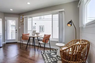 a living room with a table and chairs and a window at Bayside Bikini 2 in San Diego