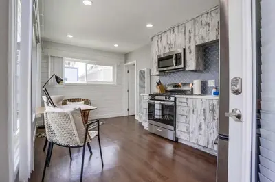 a kitchen with a table and a stove top oven at Bayside Bikini 2 in San Diego