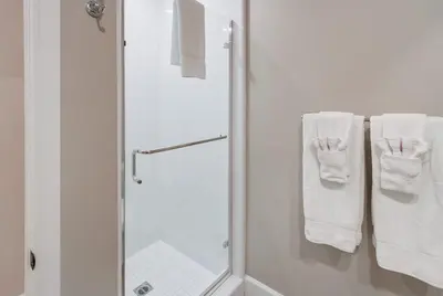 a bathroom with a shower and white towels at Bayside Cove 4 in San Diego
