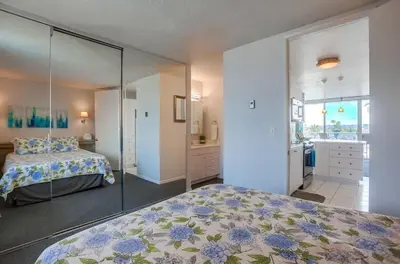 a bedroom with a bed and a glass wall at Penthouse in San Diego