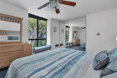 a bedroom with a bed and a large mirror at North Coast Village in Oceanside