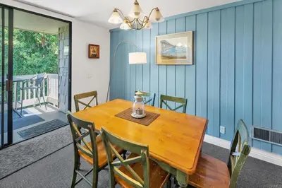 a dining room with a wooden table and chairs at North Coast Village in Oceanside