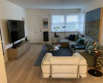 a living room with a couch and a tv at Canyon View Cutie in San Diego