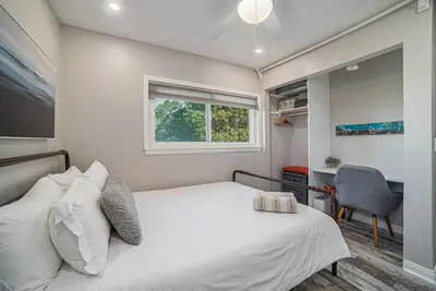 a bedroom with a bed and a window and a desk at One bedroom retreat full kitchen/laundry 1GB Wi-Fi in Bonita