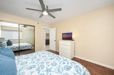 a bedroom with a bed and a ceiling fan at 4 bedroom home with Patio 10 seconds from the Sand in Newport Beach