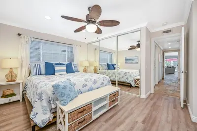 a bedroom with a bed and a mirror at Giant 7 Bedroom Home with 3 separate Condos in Newport Beach