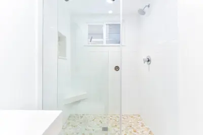 a bathroom with a shower with a glass door at BRAND NEW Luxury 1 Bedroom Condo Steps from the Beach in Newport Beach