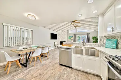 a large kitchen with a table and chairs in it at Perfect 3 Bedroom Home between the Bay and Beach in Newport Beach
