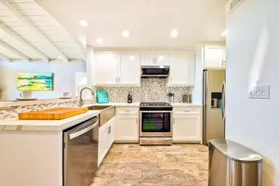 a kitchen with white cabinets and stainless steel appliances at Perfect 3 Bedroom Home between the Bay and Beach in Newport Beach