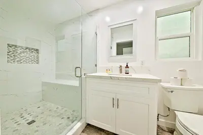 a white bathroom with a sink and a shower at Perfect 3 Bedroom Home between the Bay and Beach in Newport Beach