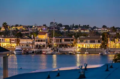 a marina with boats in the water at night at 2 Story Home with Rooftop Deck next to the Bay & Beach in Newport Beach