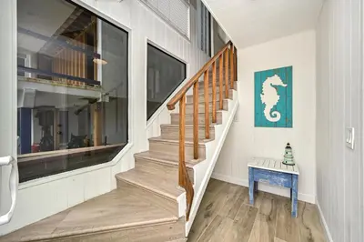 a staircase in a house with a blue table at Oceanfront Home with UNOBSTRUCTED VIEW in Newport Beach
