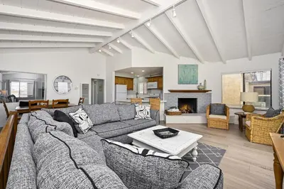 a living room with a couch and a table at Oceanfront Home with UNOBSTRUCTED VIEW in Newport Beach