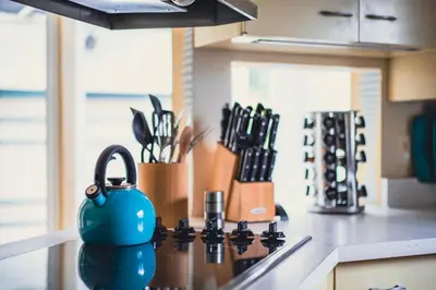 a kitchen counter with a blue tea kettle on the stove at La Jolla Shores Oceanview Retreat in San Diego