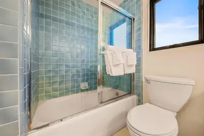 a bathroom with a toilet and a glass shower at Spacious Beautiful Home with Stunning Bay Views in San Diego