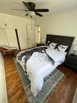 a bedroom with a bed and a ceiling fan at The Dugout in San Diego
