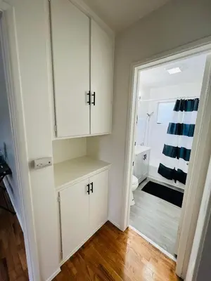 a bathroom with white cabinets and a toilet at The Dugout in San Diego