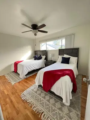 a bedroom with two beds and a ceiling fan at The Dugout in San Diego
