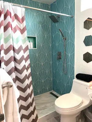a bathroom with a shower with a toilet and a shower curtain at Right In The Heart Of Pacific Beach in San Diego