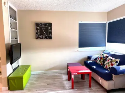 a living room with a couch and a tv at Right In The Heart Of Pacific Beach in San Diego