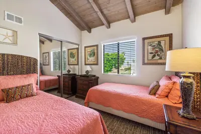 a bedroom with two beds and a mirror at 2 Bedroom Home on the Beach with Ocean View in Newport Beach