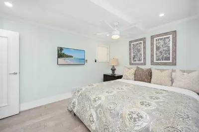 a bedroom with a bed and a ceiling fan at 2 Bedroom Oceanfront with Patio on the Boardwalk in Newport Beach