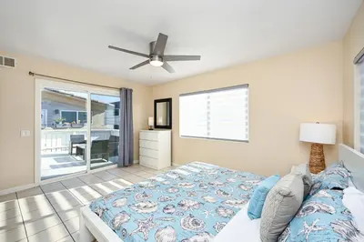 a bedroom with a bed and a ceiling fan at 6 Bedroom home located 2 houses in from the Beach in Newport Beach