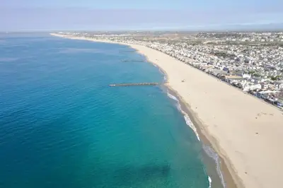 an aerial view of a beach and the ocean at 4 Bedroom Home with Rooftop & Peek-A-Boo Ocean View in Newport Beach