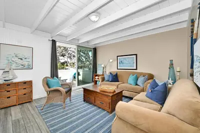 a living room with two couches and a table at 5 Bedroom 4 Bath Duplex with Parking on 46th St! in Newport Beach