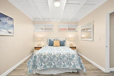 a bedroom with a bed and two night stands at 5 Bedroom 4 Bath Duplex with Parking on 46th St! in Newport Beach