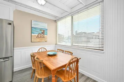 a dining room with a table and chairs and a window at 2 Bedroom Upstairs Apt 1 block from the beach! in Newport Beach