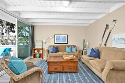a living room with two couches and a coffee table at 2 Bedroom Upstairs Apt 1 block from the beach! in Newport Beach