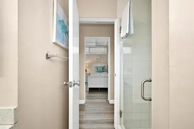 a hallway leading to a bathroom with a shower at 2 Bedroom Upstairs Apt 1 block from the beach! in Newport Beach