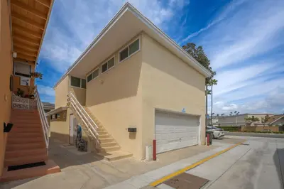 a large house with a garage and a staircase at 2 Bedroom Upstairs Apt 1 block from the beach! in Newport Beach