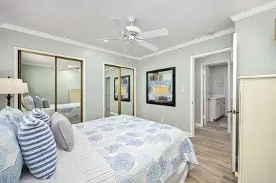a bedroom with a bed and a ceiling fan at Multi Level Oceanfront Home With Oceanviews and Private Patio on the Boardwalk in Newport Beach