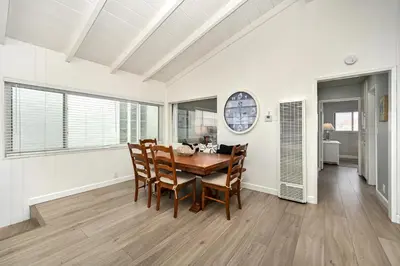 a dining room with a table and chairs at Multi Level Oceanfront Home With Oceanviews and Private Patio on the Boardwalk in Newport Beach