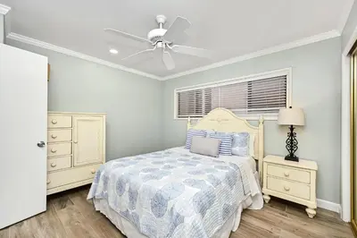 a bedroom with a bed and a ceiling fan at Updated Home with Patio on the Boardwalk near 15th St in Newport Beach