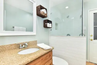 a bathroom with a sink and a mirror at Oceanfront Triplex on Boardwalk with Ocean Views and Patio in Newport Beach