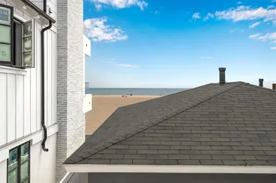 a roof of a building with the beach in the background at Oceanfront Back Home with View of the Sea in Newport Beach