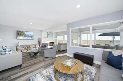 a living room with a couch and a table at Charming 2 Story and 4 Bedroom Home on the Boardwalk in Newport Beach