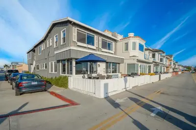 a house with a car parked in front of it at Charming 2 Story and 4 Bedroom Home on the Boardwalk in Newport Beach
