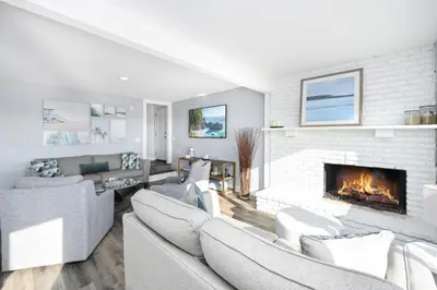 a living room with couches and a fireplace at Charming 2 Story and 4 Bedroom Home on the Boardwalk in Newport Beach