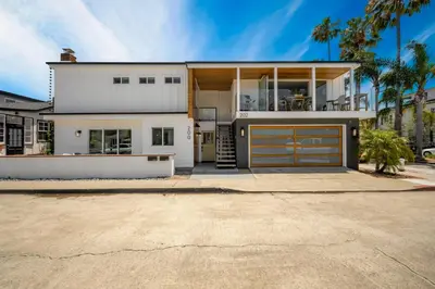 a large white house with a garage at 3 Bedroom Renovated Condo on Balboa Island in Newport Beach