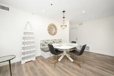 a white dining room with a table and chairs at 3 Bedroom Renovated Condo on Balboa Island in Newport Beach