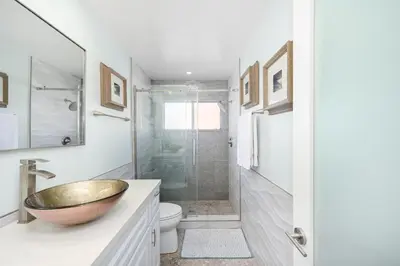 a bathroom with a sink and a shower at 5 Bedroom duplex with Patio & Balcony walk to Pier in Newport Beach
