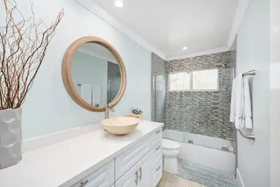 a bathroom with a sink and a mirror at 5 Bedroom duplex with Patio & Balcony walk to Pier in Newport Beach