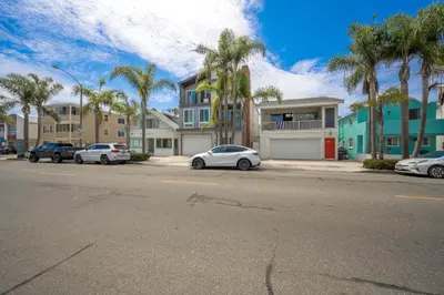 a street with cars parked in front of houses at Great Location near the Balboa Pier and Fun Zone with Air conditioning in Newport Beach
