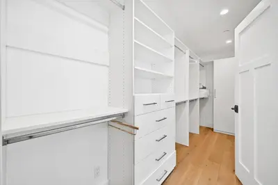 a walk in closet with white closets at 5 Bedroom Luxury Duplex across from the Beach for 11 people in Newport Beach