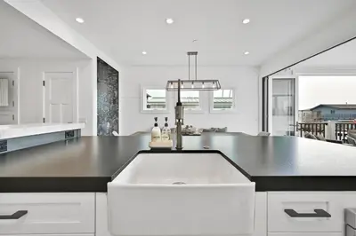 a white kitchen with a large white counter top at 4 Bedrooms in BRAND NEW Luxury built Home walk to the beach in Newport Beach