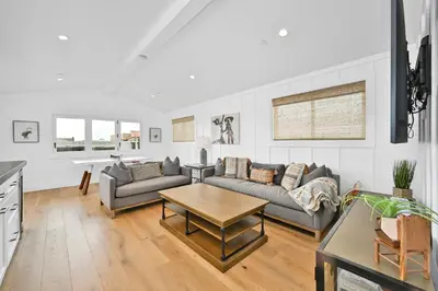 a living room with a couch and a table at 4 Bedrooms in BRAND NEW Luxury built Home walk to the beach in Newport Beach